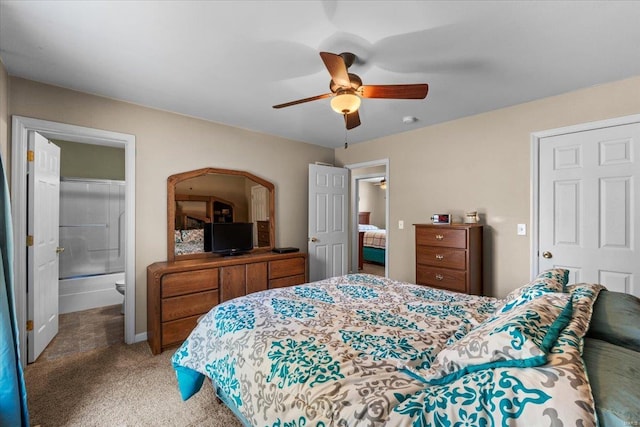 bedroom featuring light carpet, ensuite bath, and a ceiling fan