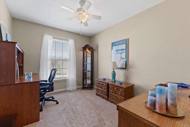 office space with carpet flooring, baseboards, and ceiling fan