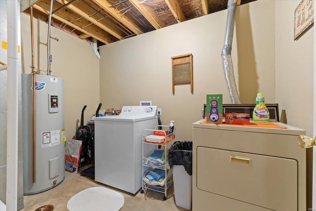 clothes washing area with independent washer and dryer, laundry area, and water heater