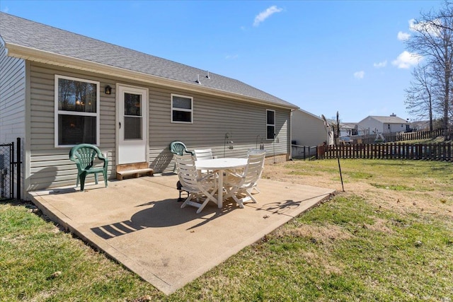 rear view of property with a patio, a yard, fence, and roof with shingles