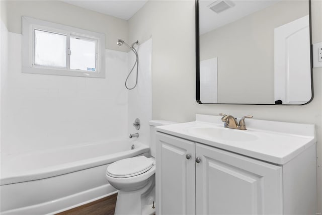 full bath with vanity, wood finished floors, visible vents, bathtub / shower combination, and toilet