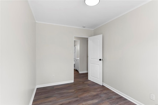 unfurnished room featuring baseboards, dark wood-style flooring, and ornamental molding