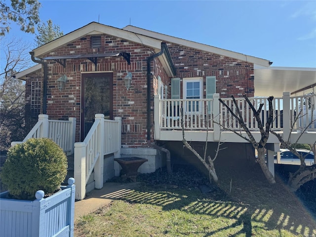 view of side of home featuring brick siding