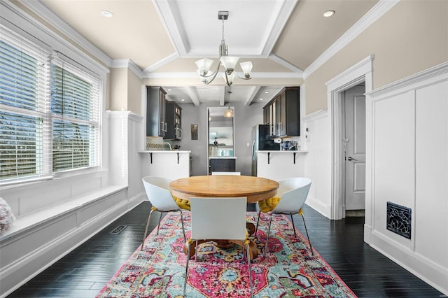 dining room with crown molding, dark wood-style flooring, and a chandelier