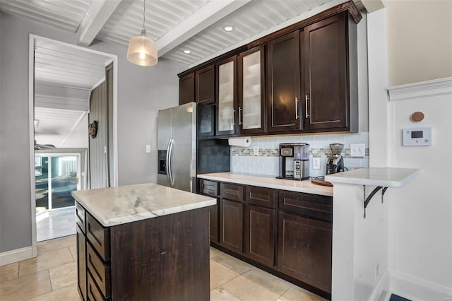 kitchen featuring decorative backsplash, light tile patterned flooring, stainless steel fridge with ice dispenser, and light countertops