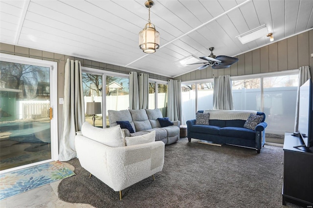 sunroom featuring wooden ceiling, ceiling fan, and vaulted ceiling