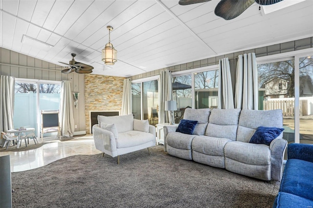 living room with a wealth of natural light and ceiling fan