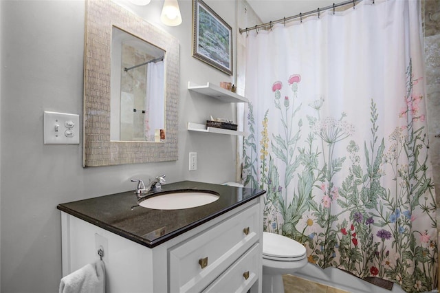 bathroom featuring a shower with shower curtain, toilet, and vanity