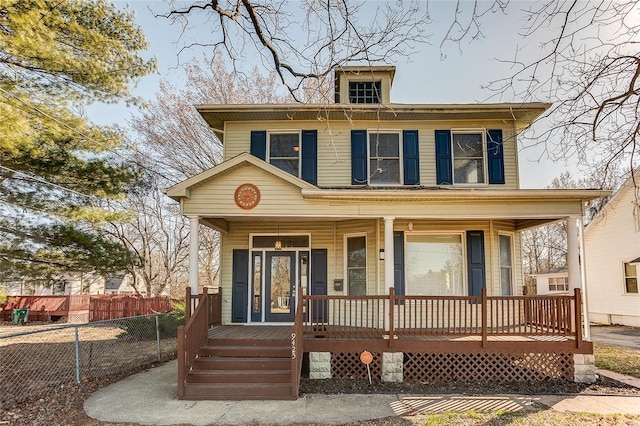 view of front of house with fence and covered porch