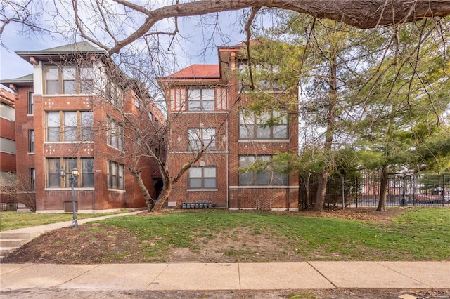 view of building exterior with fence