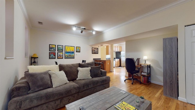 living area with visible vents, track lighting, baseboards, ornamental molding, and light wood-style floors