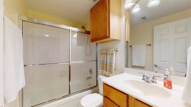 full bath featuring combined bath / shower with glass door, visible vents, toilet, and vanity