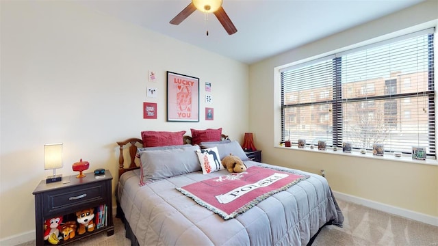 bedroom featuring a ceiling fan, carpet, and baseboards