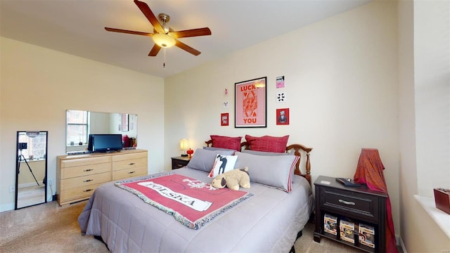 bedroom with light carpet and a ceiling fan