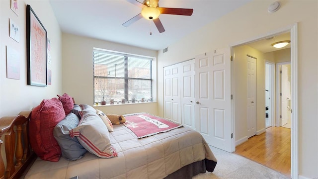 bedroom featuring visible vents, light carpet, a closet, and a ceiling fan