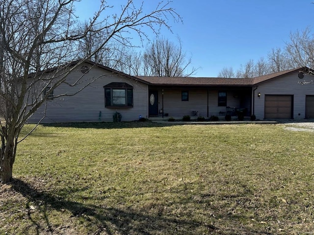 single story home featuring a front lawn, an attached garage, and driveway