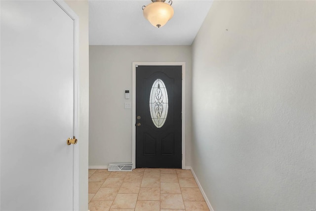 foyer entrance with light tile patterned floors, visible vents, and baseboards