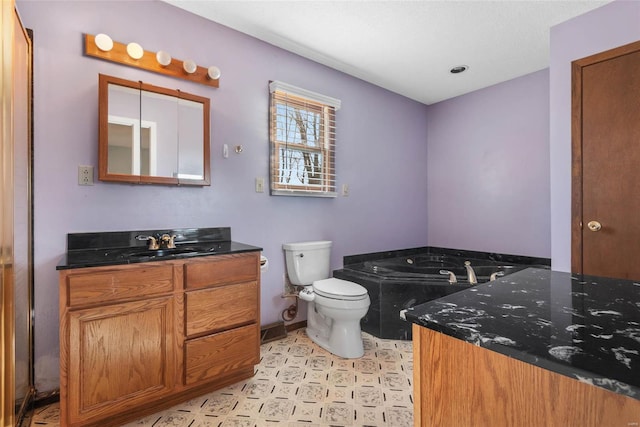 bathroom featuring a bath, toilet, vanity, and baseboards