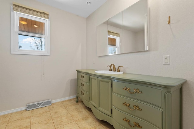 bathroom featuring tile patterned flooring, visible vents, vanity, and baseboards