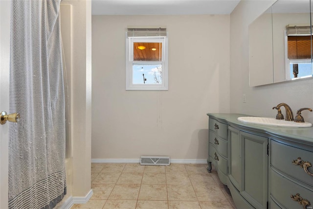 bathroom with visible vents, a shower with shower curtain, tile patterned flooring, baseboards, and vanity