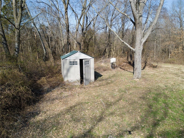 view of shed featuring a wooded view