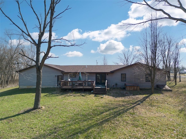 rear view of house with a lawn and a deck