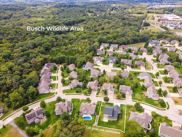 bird's eye view featuring a forest view and a residential view