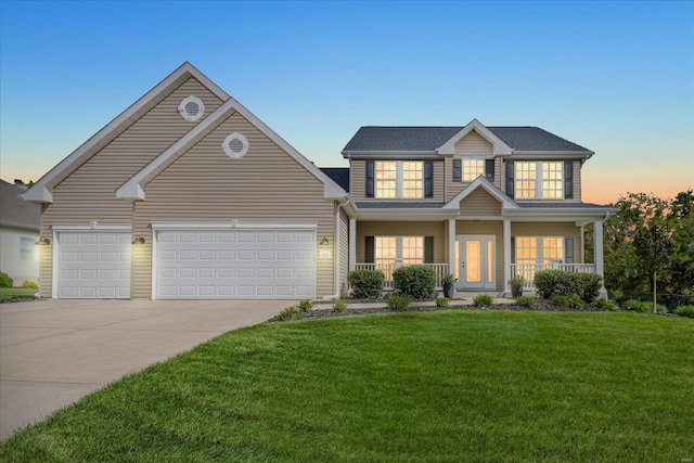 view of front of home featuring a garage, concrete driveway, a yard, and covered porch