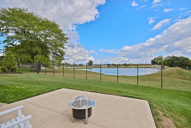 view of patio / terrace with a fire pit and a water view