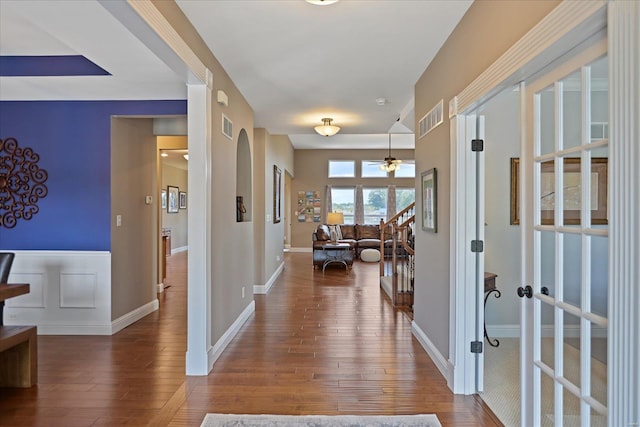 foyer with visible vents, baseboards, and wood finished floors