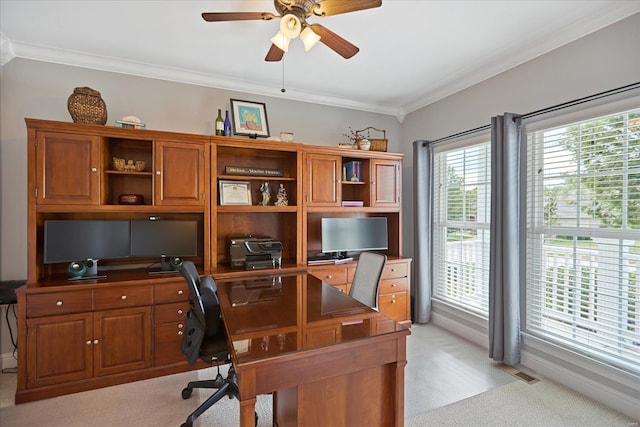 office space with light carpet, visible vents, a ceiling fan, and ornamental molding