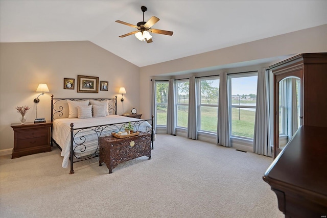 bedroom featuring light colored carpet, a ceiling fan, and vaulted ceiling