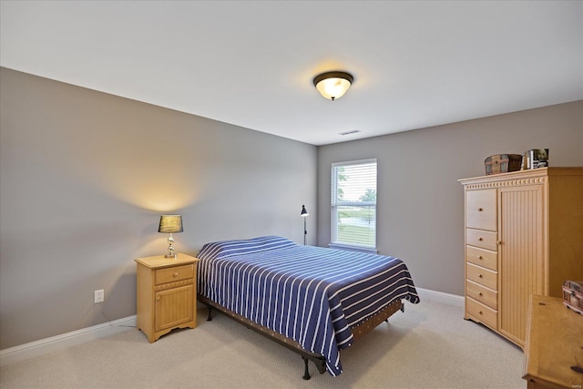 bedroom with visible vents, light colored carpet, and baseboards