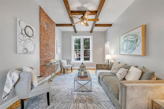 living area featuring beamed ceiling, baseboards, and ceiling fan