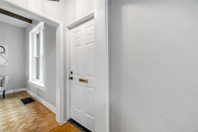 doorway to outside featuring visible vents and baseboards