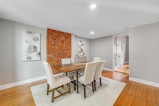 dining room with recessed lighting, baseboards, and light wood-style floors