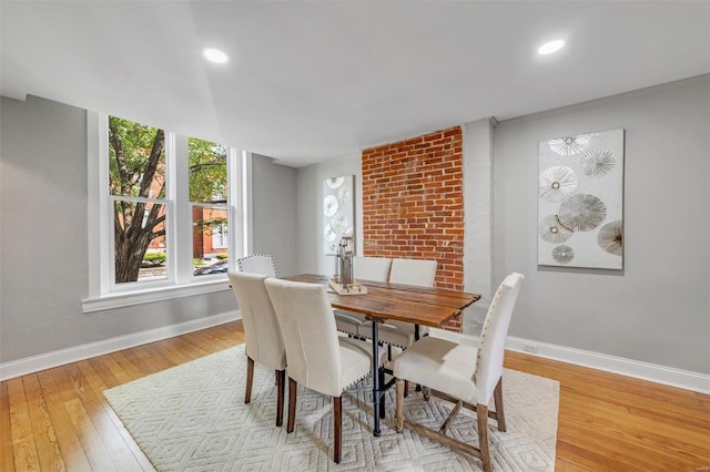 dining room featuring hardwood / wood-style flooring, recessed lighting, and baseboards