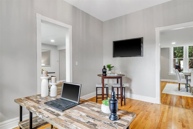 home office featuring baseboards and hardwood / wood-style flooring