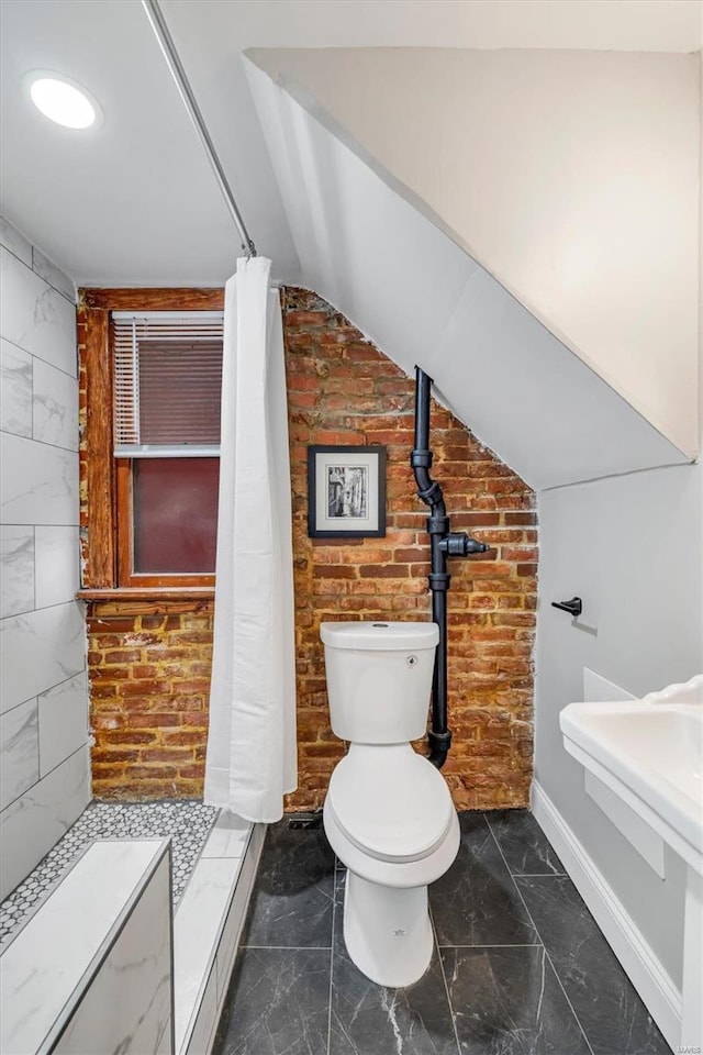 full bathroom featuring baseboards, tiled shower, vaulted ceiling, toilet, and marble finish floor