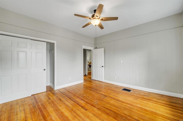 unfurnished bedroom with light wood-type flooring, visible vents, baseboards, and ceiling fan