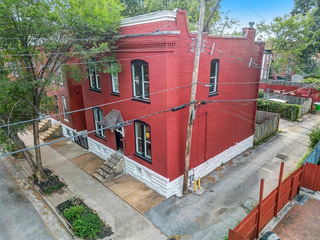 exterior space featuring entry steps and fence