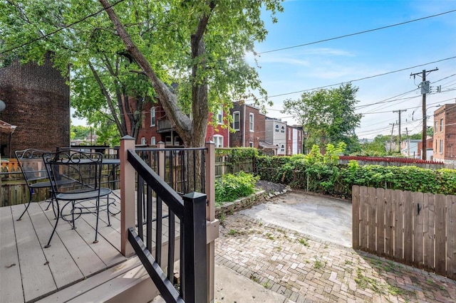 wooden deck featuring outdoor dining space and fence