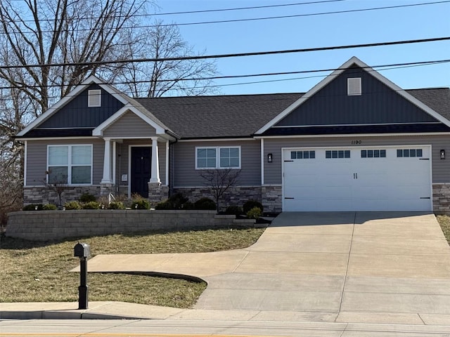 craftsman inspired home with stone siding, concrete driveway, an attached garage, and a shingled roof