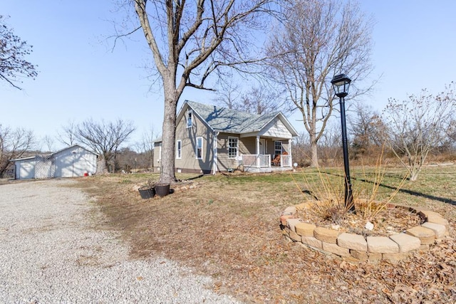 view of front facade with an outbuilding and covered porch