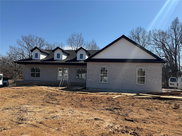 rear view of house with brick siding