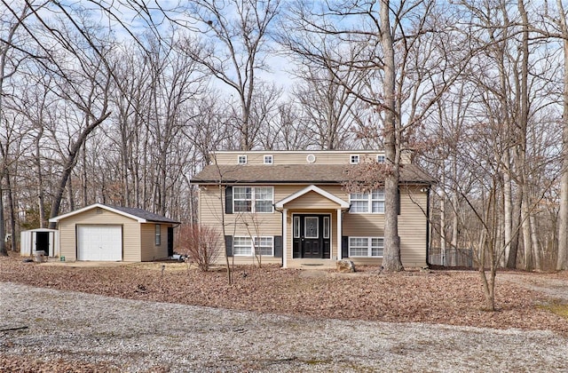 raised ranch with a garage and an outdoor structure