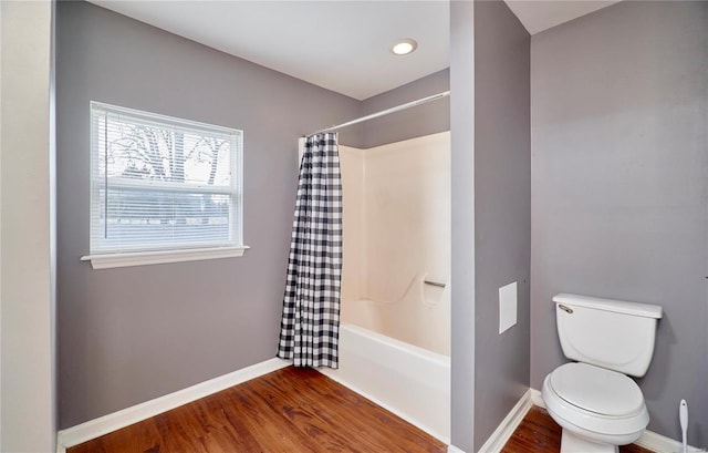 bathroom with wood finished floors and baseboards