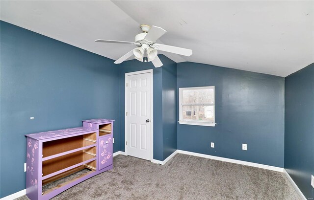 carpeted bedroom featuring baseboards, lofted ceiling, and ceiling fan