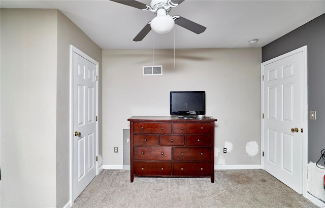 bedroom featuring a ceiling fan, light colored carpet, visible vents, and baseboards