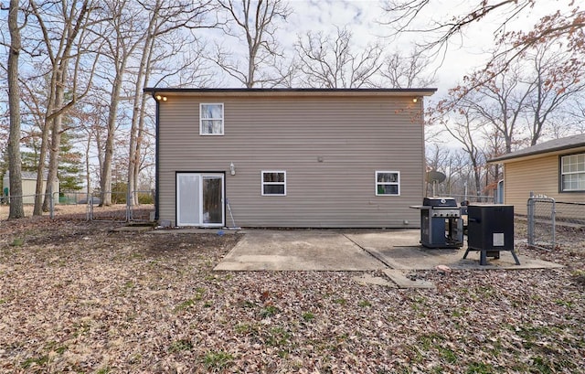 rear view of property with a patio and fence